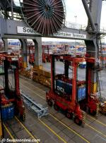 ID 1891 PORT OF SOUTHAMPTON, ENGLAND - Straddle carrier, crane and container stacks in background.